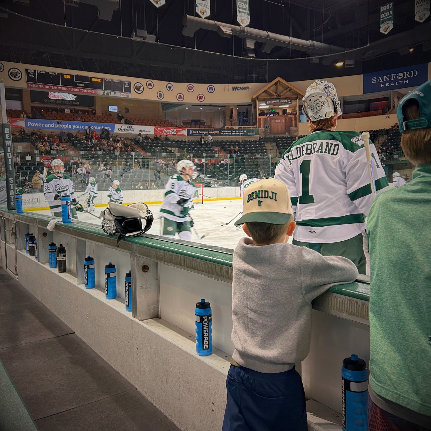 UGC view of natural and green Bemidji 5-panel cap with puff lettering at Bemidji State game